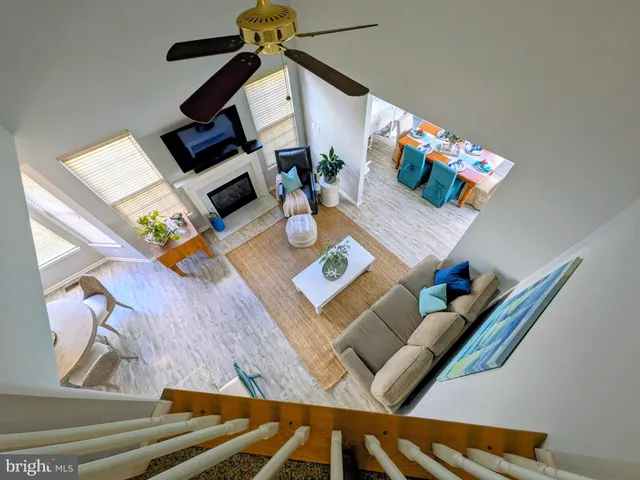 a living room with furniture and floor to ceiling windows