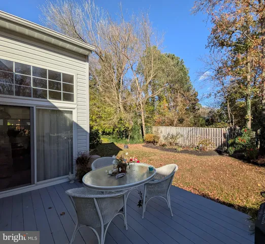 a view of a chairs and table on the wooden deck