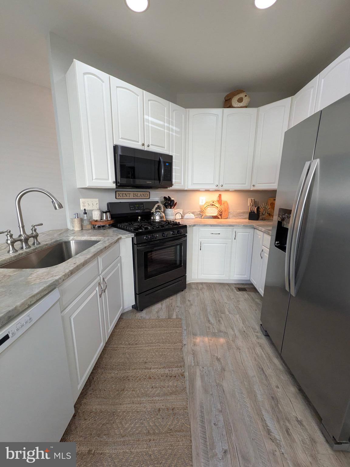 112 Chessie Court Chester, MD 21619 - Photo 8 of 37 a large kitchen with cabinets and stainless steel appliances