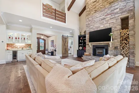 a living room with fireplace furniture and a flat screen tv