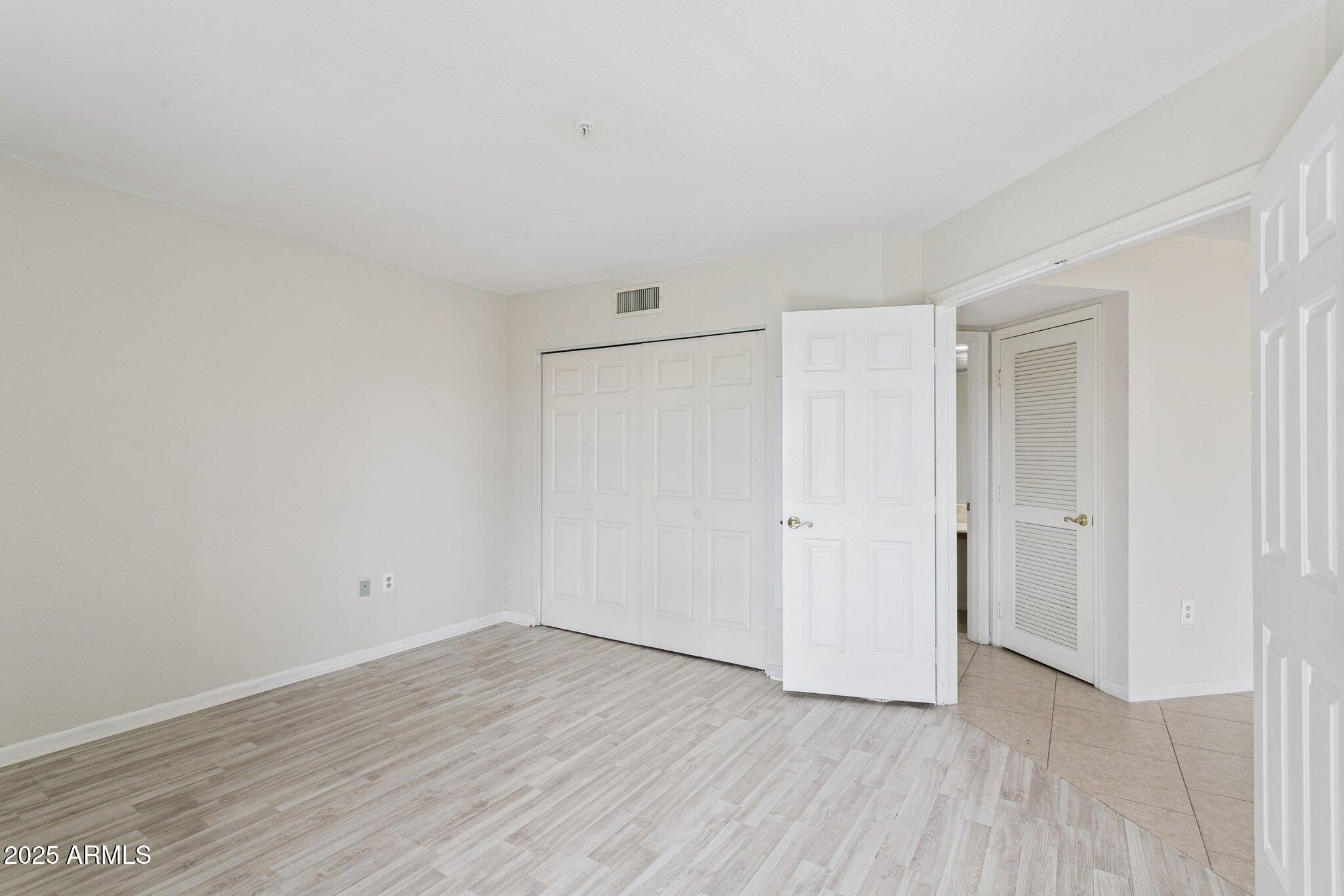 4200 North Miller Road, Unit 220 Scottsdale, AZ 85251 - Photo 16 of 27 a view of an empty room with wooden floor