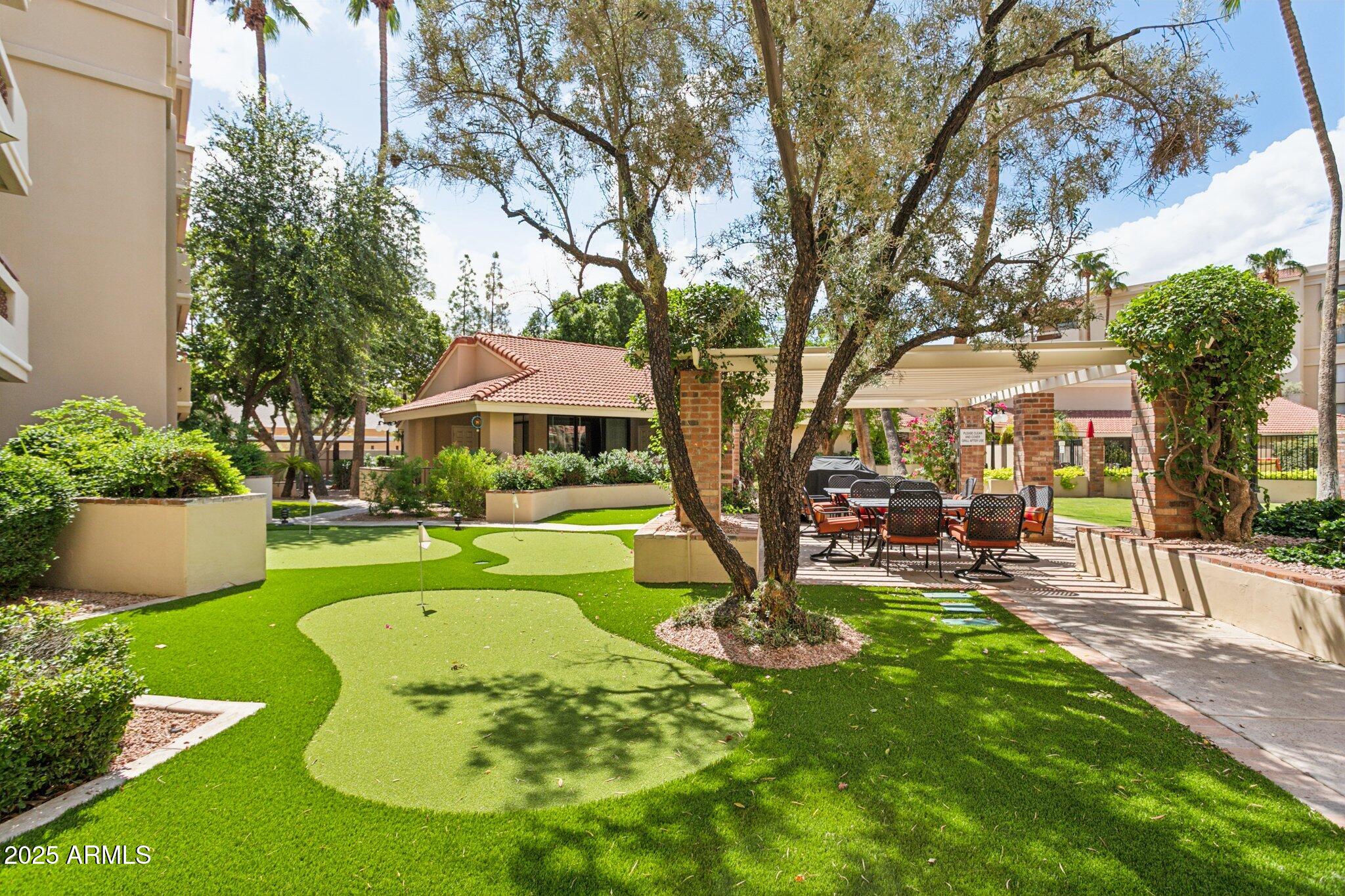 4200 North Miller Road, Unit 220 Scottsdale, AZ 85251 - Photo 22 of 27 a view of a house with a swimming pool and sitting area