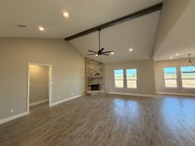 230 Kilkenny Road Poolville, TX 76487 - Photo 4 of 22 an empty room with wooden floor fireplace and windows