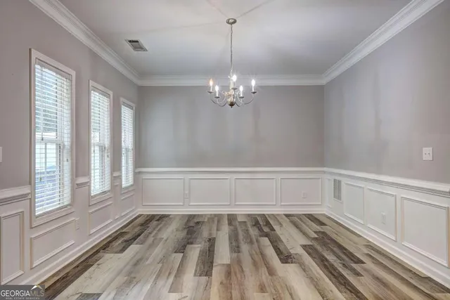 a view of a room with wooden floor and windows