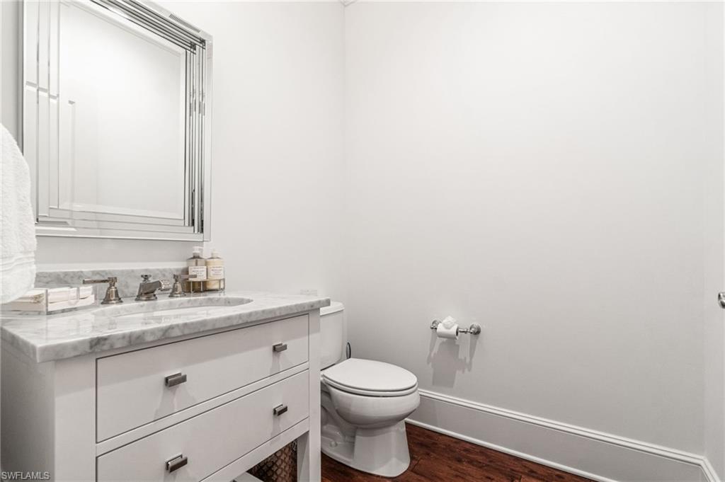 16755 Lucarno Way Naples, FL 34110 - Photo 23 of 50 a bathroom with a toilet a sink and mirror