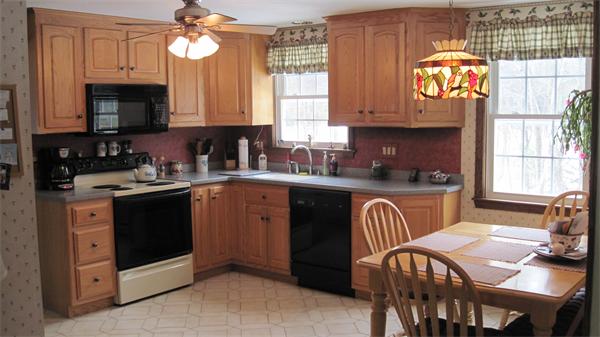 20 Green Valley Road Medway, MA 02053 - Photo 8 of 13 a kitchen with granite countertop a stove a sink and a microwave