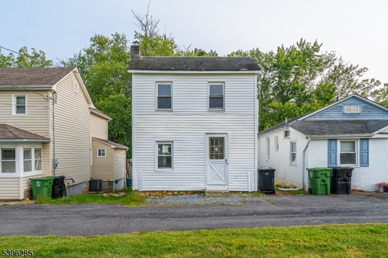 a view of a white house with a yard and plants