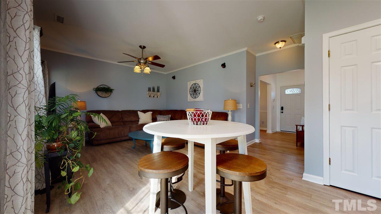 5404 Neuse Forest Road Raleigh, NC 27616 - Photo 11 of 29 a view of a dining room with furniture and wooden floor