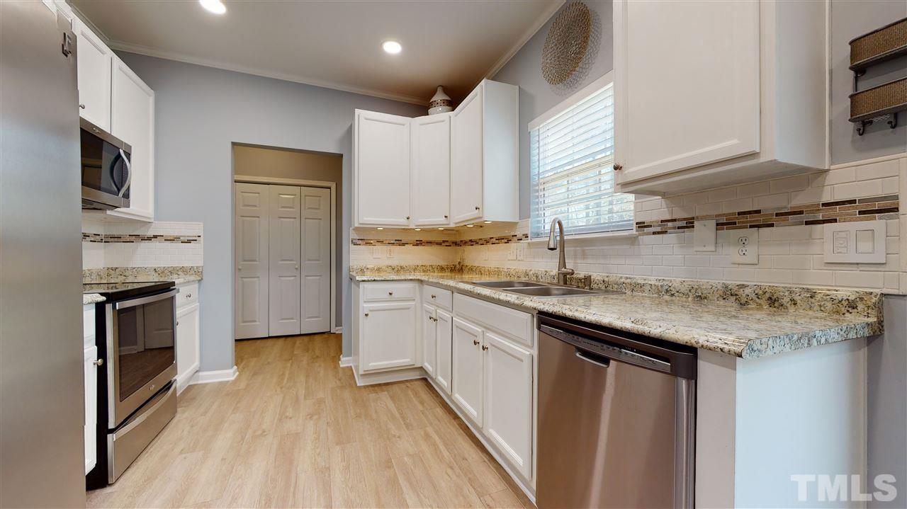 5404 Neuse Forest Road Raleigh, NC 27616 - Photo 12 of 29 a kitchen with stainless steel appliances granite countertop a sink stove and refrigerator