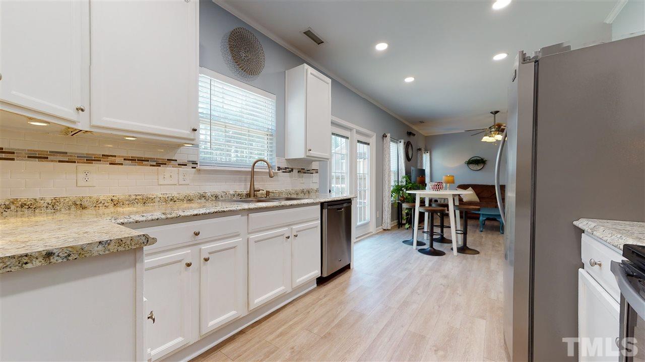 5404 Neuse Forest Road Raleigh, NC 27616 - Photo 13 of 29 a kitchen with granite countertop a sink cabinets and wooden floor