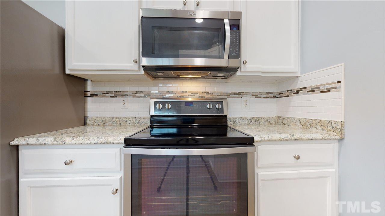 5404 Neuse Forest Road Raleigh, NC 27616 - Photo 14 of 29 a kitchen with stainless steel appliances granite countertop a stove and a microwave