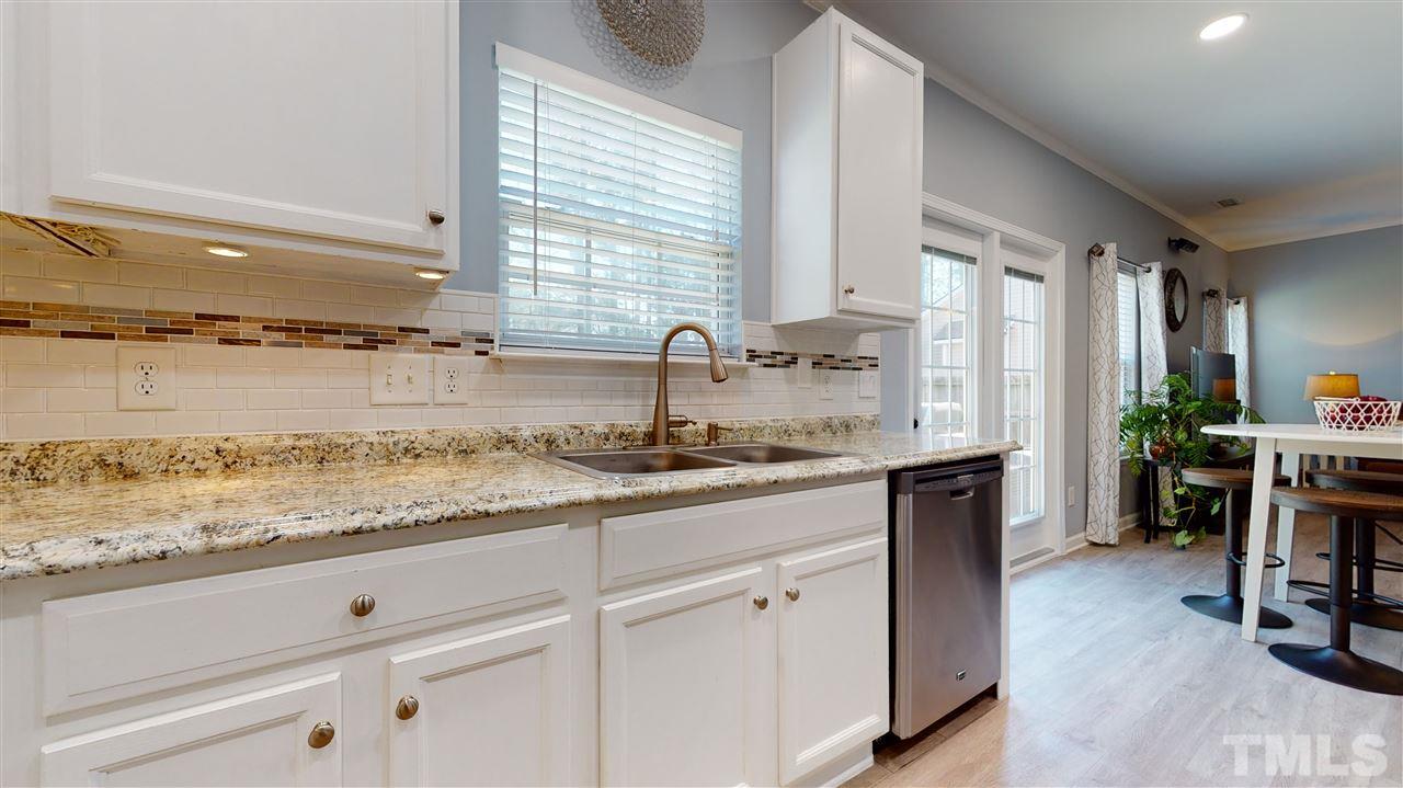 5404 Neuse Forest Road Raleigh, NC 27616 - Photo 16 of 29 a kitchen with sink stove and cabinets