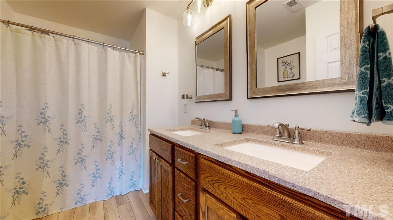 5404 Neuse Forest Road Raleigh, NC 27616 - Photo 19 of 29 a bathroom with a granite countertop sink and a mirror