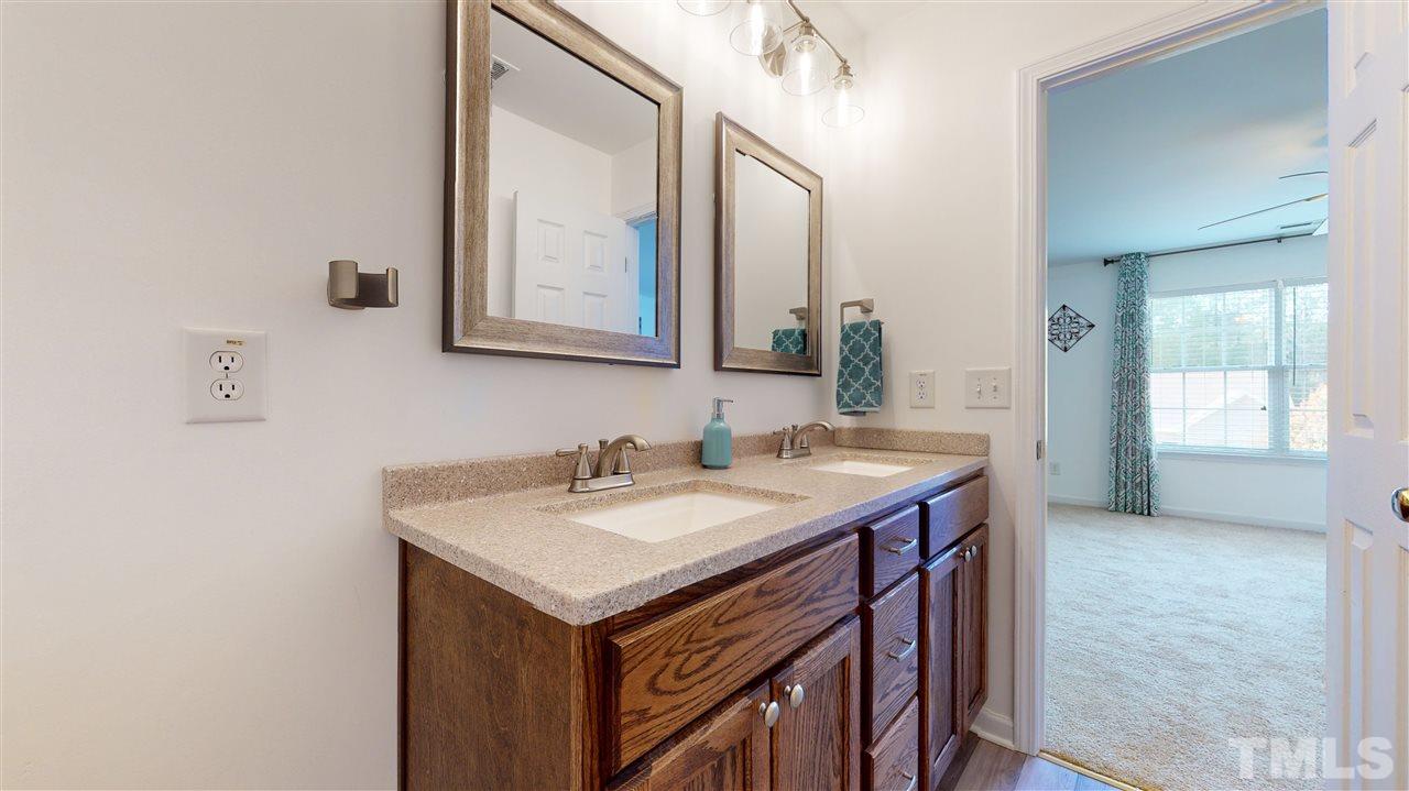 5404 Neuse Forest Road Raleigh, NC 27616 - Photo 20 of 29 a bathroom with a sink and a mirror
