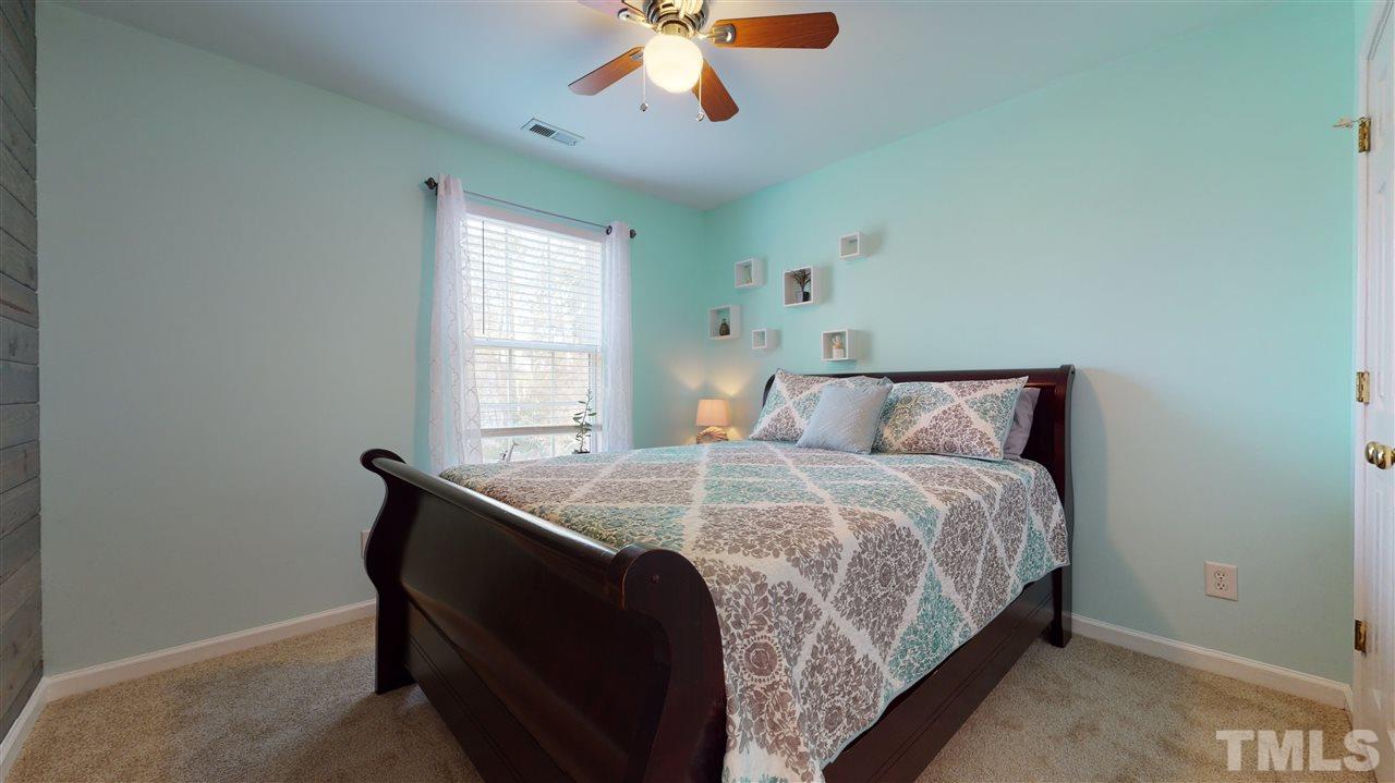 5404 Neuse Forest Road Raleigh, NC 27616 - Photo 22 of 29 a bedroom with a bed and window