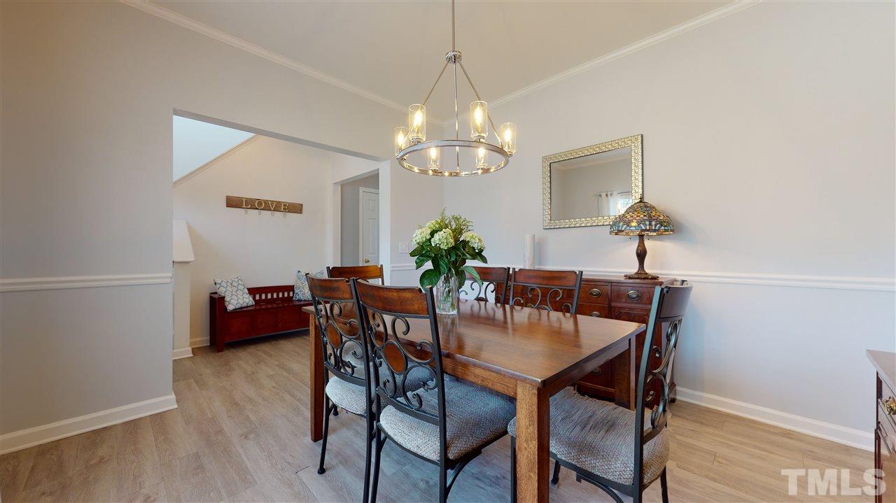 5404 Neuse Forest Road Raleigh, NC 27616 - Photo 7 of 29 a view of a dining room with furniture and chandelier