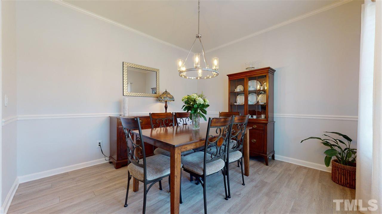 5404 Neuse Forest Road Raleigh, NC 27616 - Photo 8 of 29 a view of a dining room with furniture and wooden floor