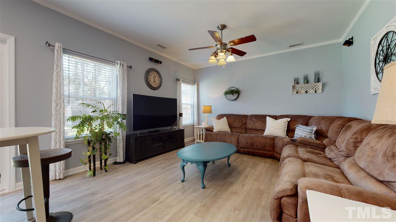5404 Neuse Forest Road Raleigh, NC 27616 - Photo 9 of 29 a living room with furniture a window and a flat screen tv