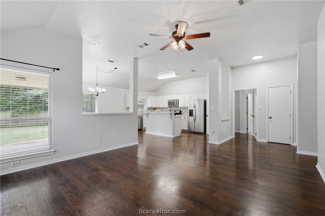 1707 Beaver Pond Court Bryan, TX 77807 - Photo 6 of 33 Spacious interior featuring wood-look flooring, vaulted ceilings, and a ceiling fan