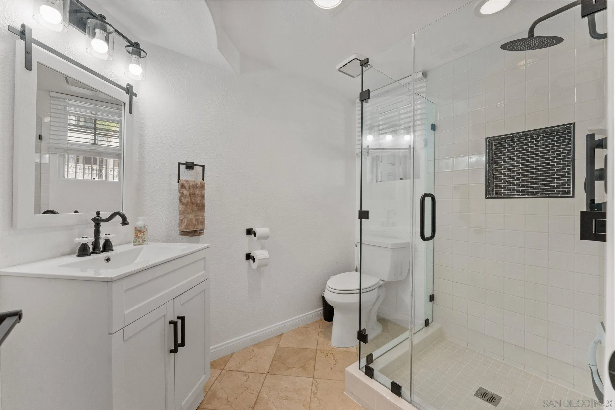 2842 Torrey Pines Road La Jolla, CA 92037 - Photo 40 of 45 a bathroom with a sink toilet a shower and a mirror