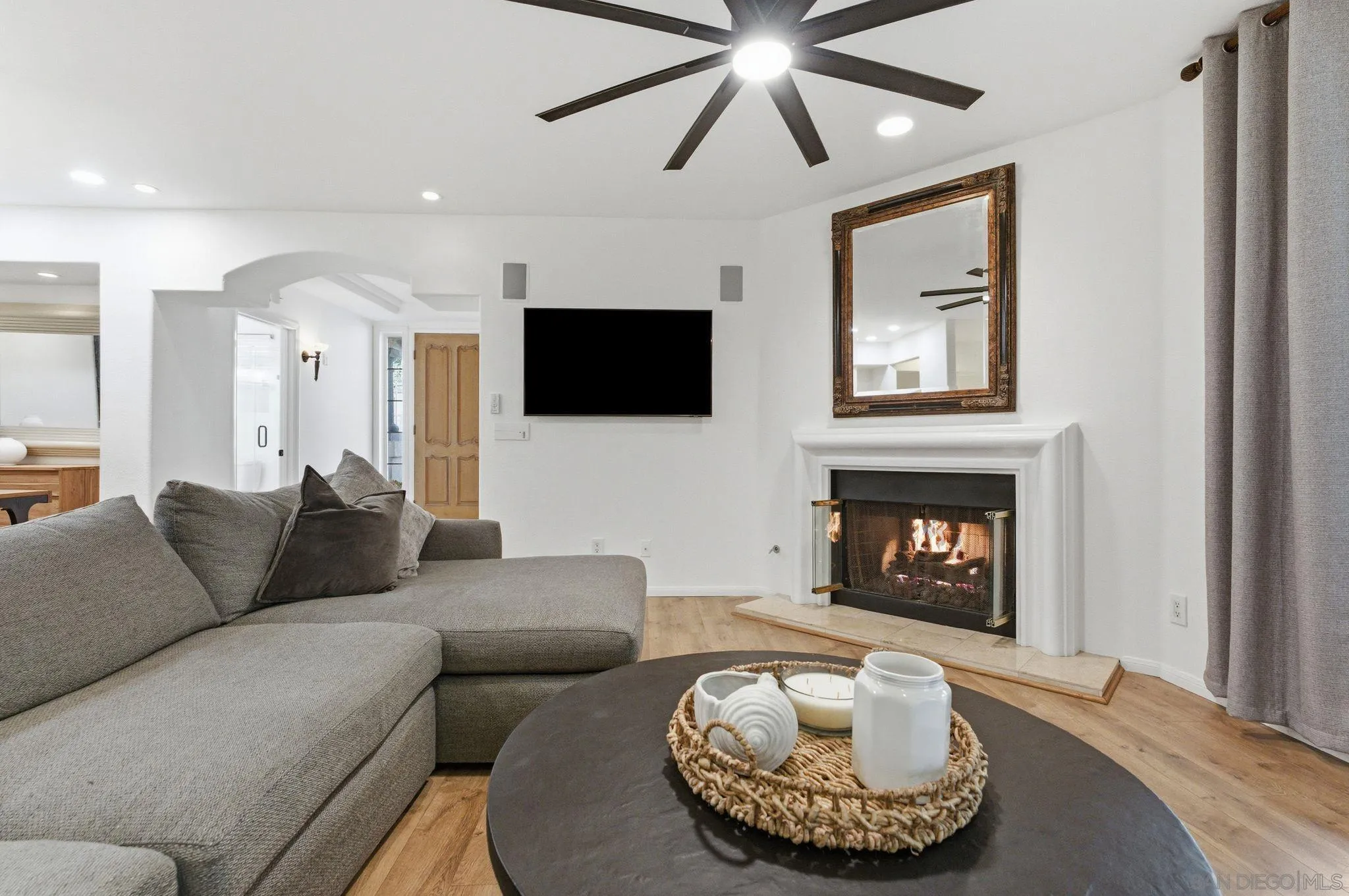 2842 Torrey Pines Road La Jolla, CA 92037 - Photo 5 of 45 a living room with furniture a fireplace and a flat screen tv