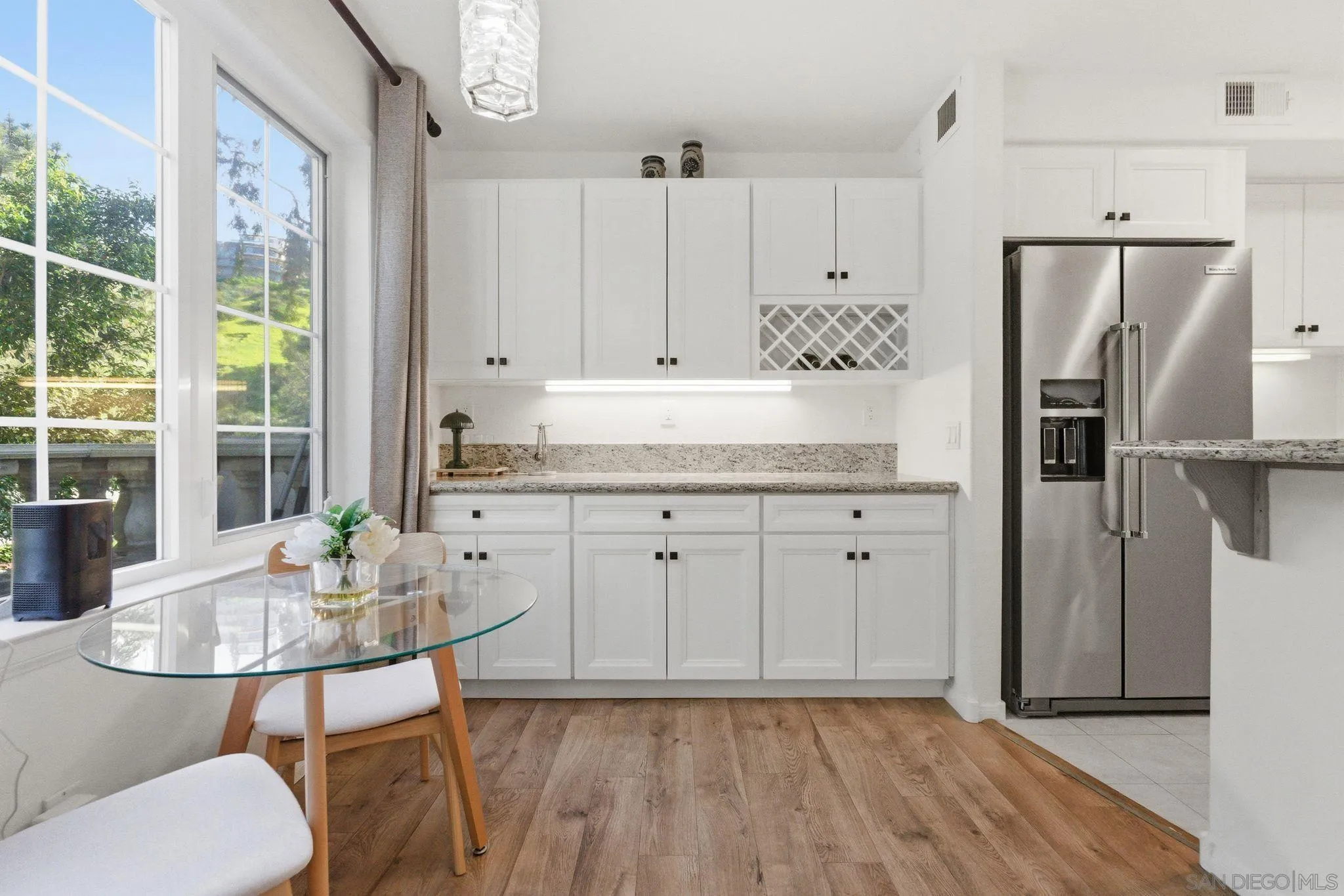 2842 Torrey Pines Road La Jolla, CA 92037 - Photo 10 of 45 a kitchen with granite countertop a table chairs stove and refrigerator