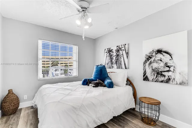 a bedroom with a bed and a painting on the wall