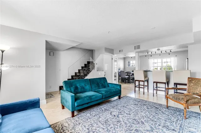 a living room with furniture and a rug