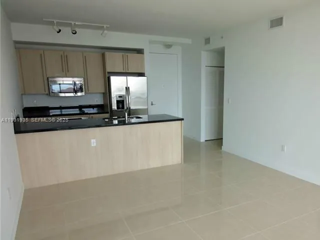 a kitchen with stainless steel appliances a sink and a microwave