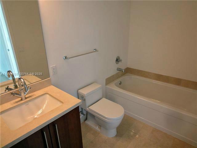 79 Southwest 12th Street, Unit 3502S Miami, FL 33130 - Photo 4 of 18 a bathroom with a sink a toilet and bathtub