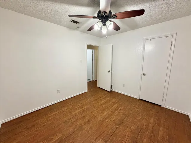 an empty room with a fan and a fan