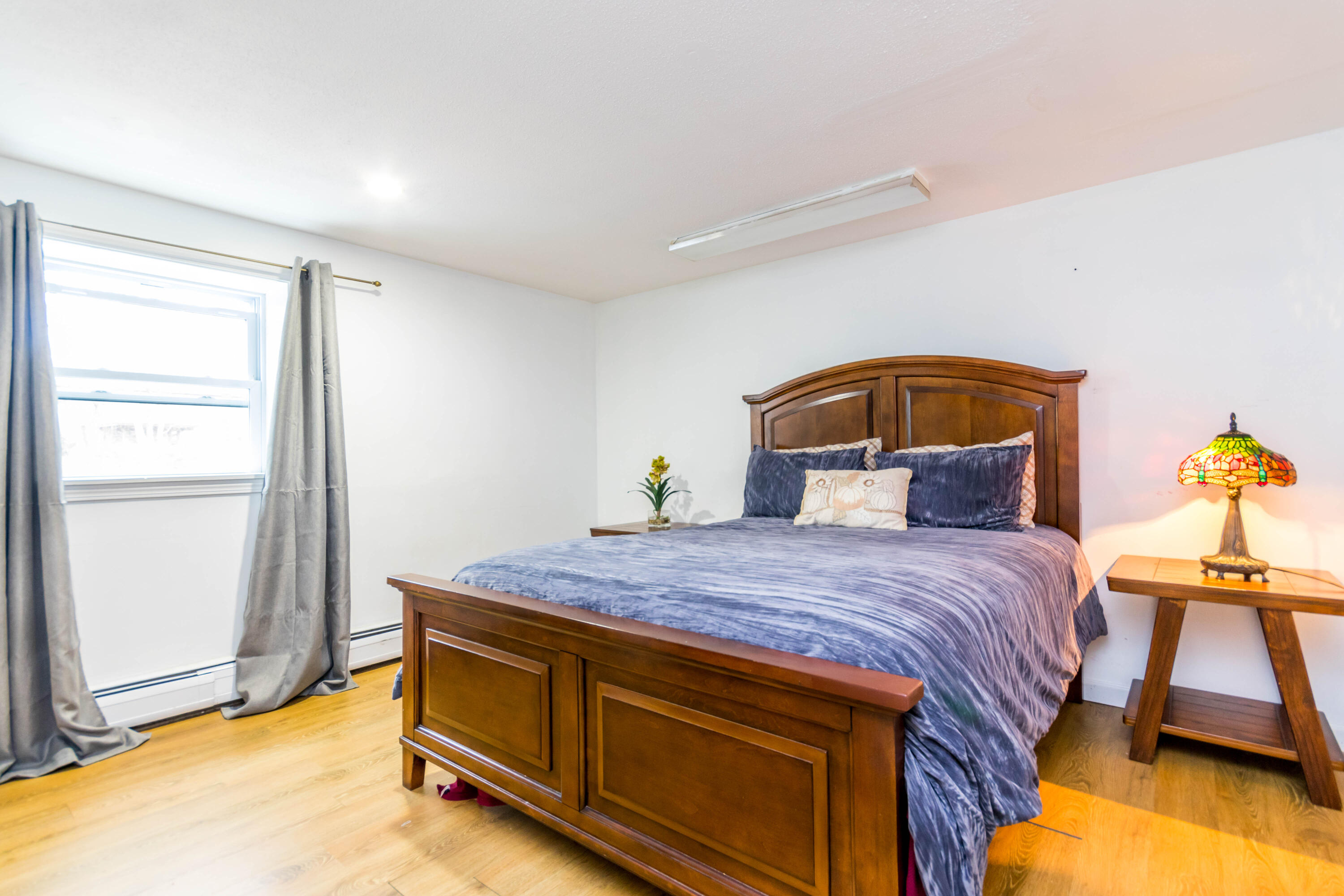 59 North Precinct Road Centerville, MA 02632 - Photo 20 of 30 a bedroom with a bed and wooden floor