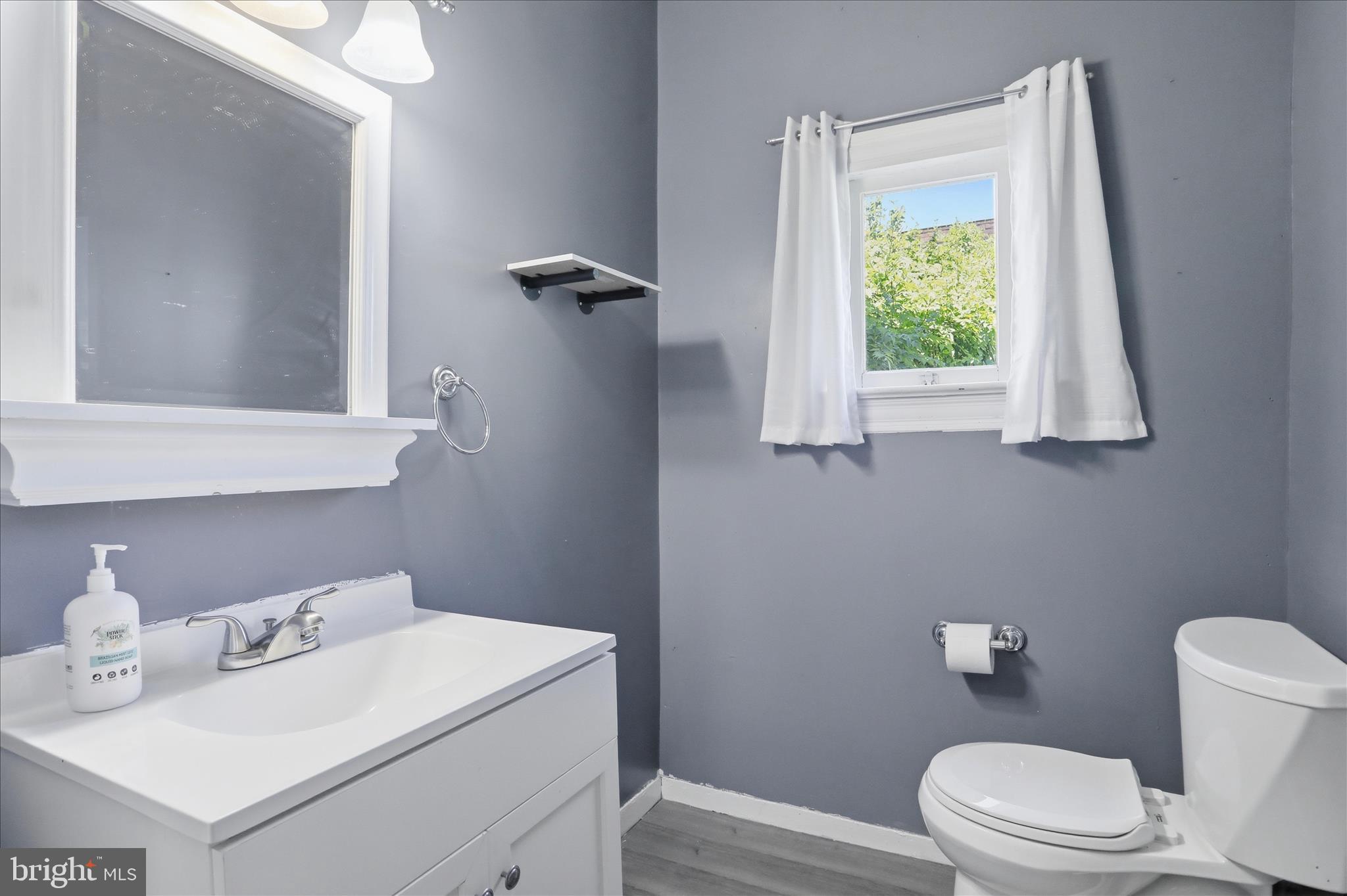 21 Sharpless Street Keyser, WV 26726 - Photo 7 of 33 a bathroom with a sink vanity mirror and toilet