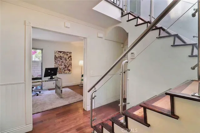 a view of a hallway with workspace and wooden floor