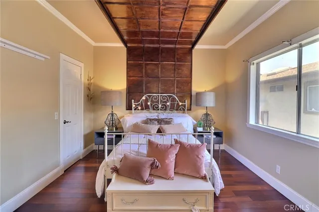 a view of a dining room with furniture a chandelier and wooden floor