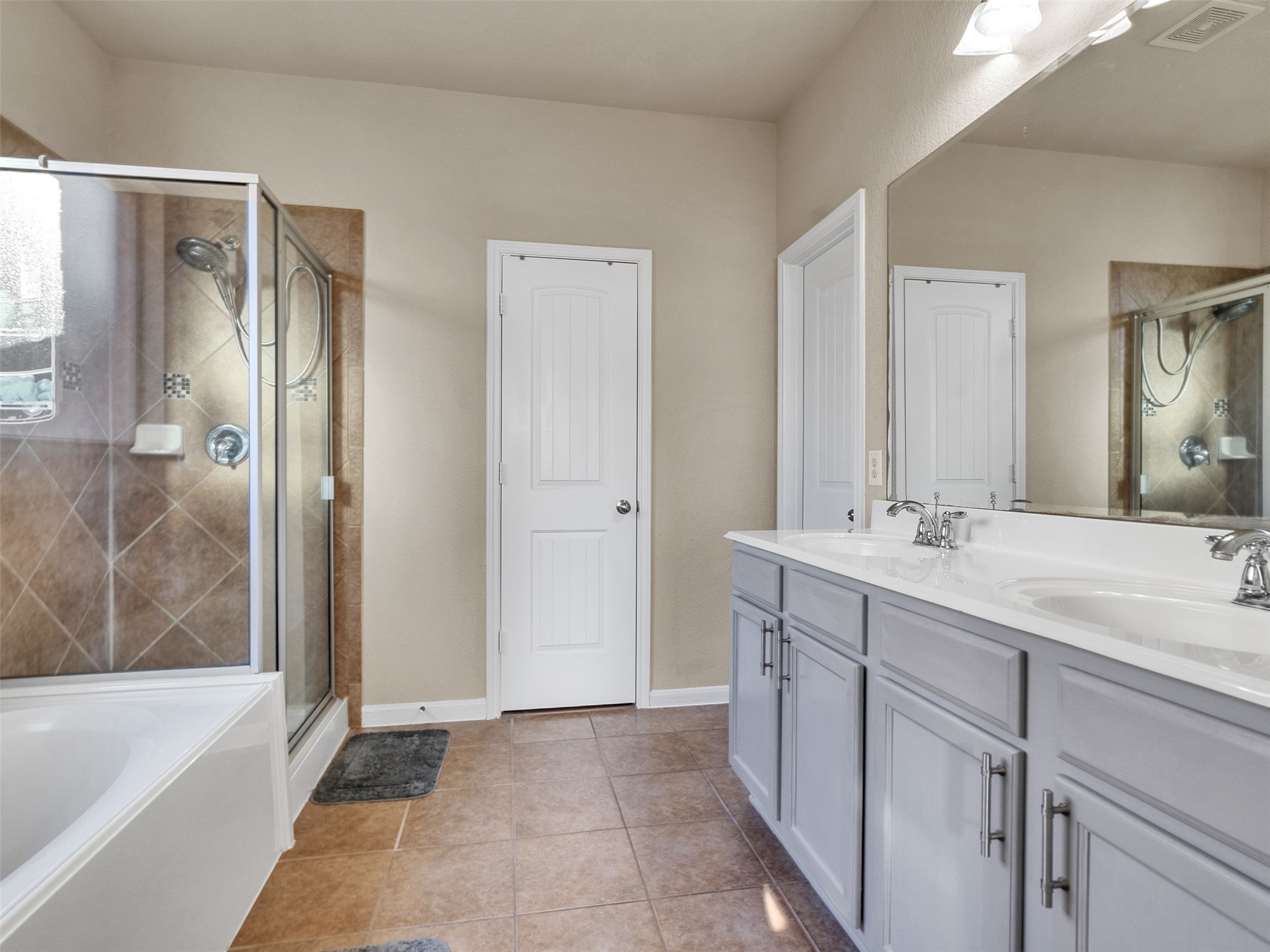 522 Summer Mist Lane Rosenberg, TX 77469 - Photo 18 of 36 Double the sinks, double the style! Loving the fresh look of this gray vanity paired with that huge mirror—it makes the whole space feel so bright and open. Who else needs a soaking tub like this?
