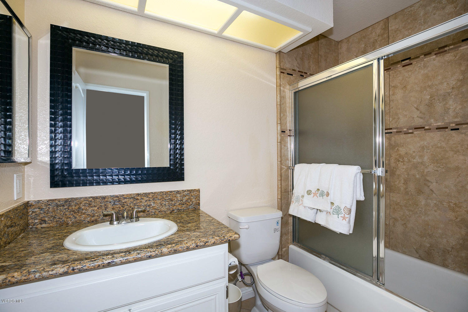 539 Galloping Hill Road Simi Valley, CA 93065 - Photo 23 of 30 a bathroom with a granite countertop sink toilet a mirror and shower
