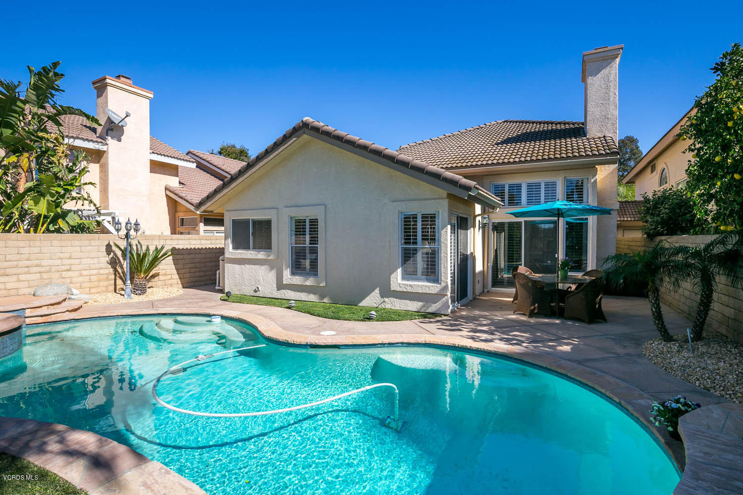 539 Galloping Hill Road Simi Valley, CA 93065 - Photo 26 of 30 a view of a house with backyard swimming pool and sitting area