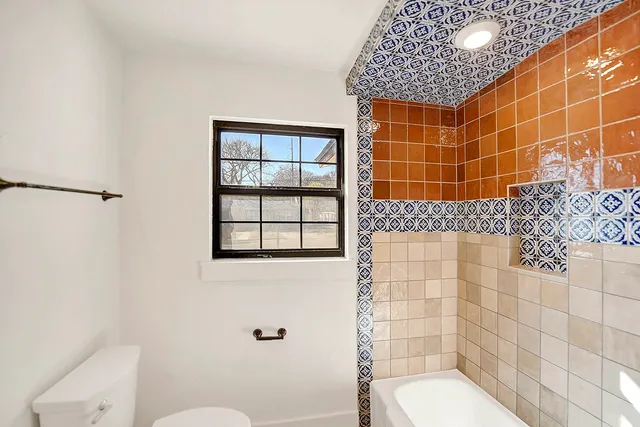 a bathroom with a toilet and shower