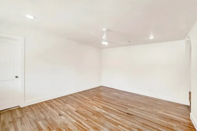 a view of empty room with wooden floor