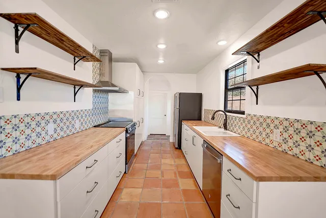 a spacious bathroom with a double vanity sink and a large mirror