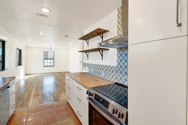 a kitchen with granite countertop a stove and a refrigerator