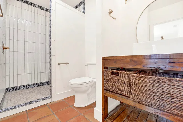 a bathroom with a toilet and a shower