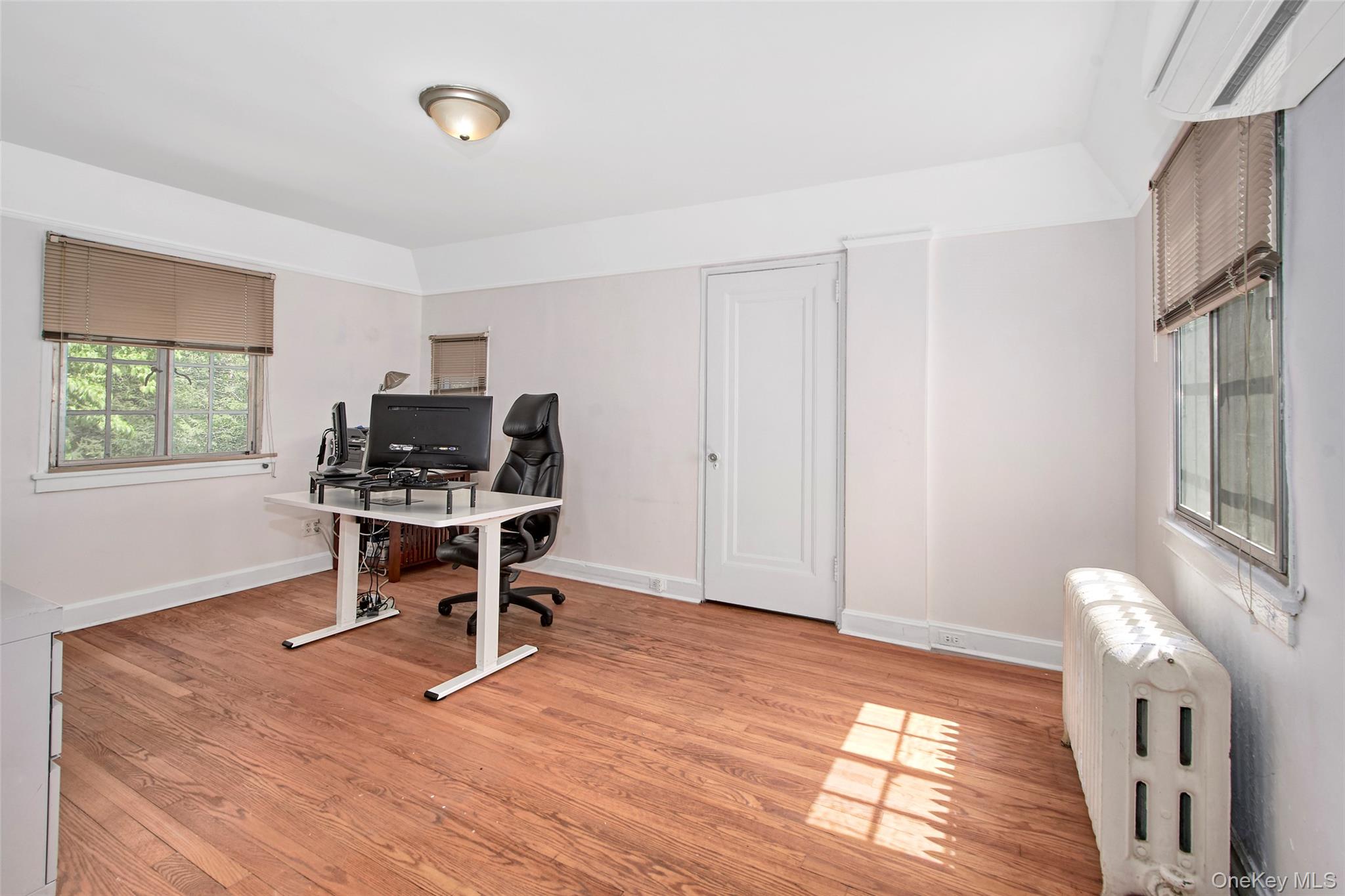 2 Byworth Road New Rochelle, NY 10804 - Photo 24 of 31 Office area with an AC wall unit, radiator, baseboards, and light wood-type flooring