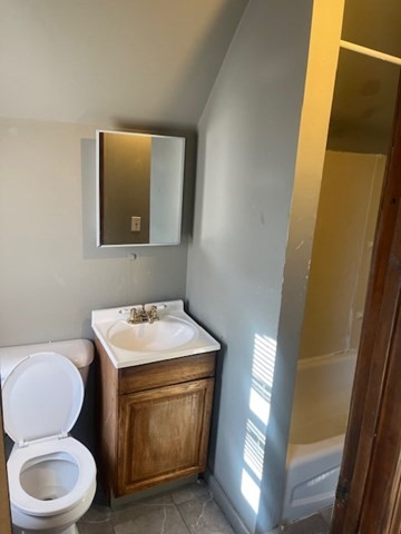 14 Adams Street, Unit 3 Taunton, MA 02780 - Photo 4 of 6 a bathroom with a toilet a sink a vanity and mirror