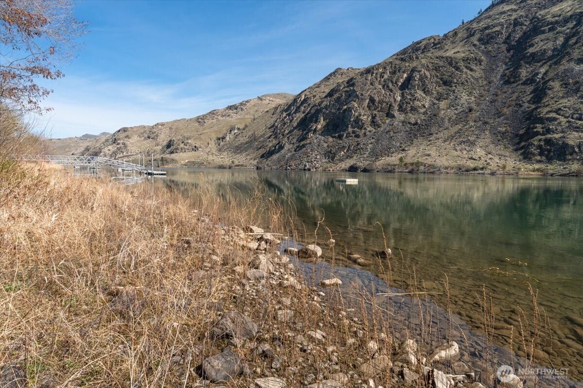 519 Hidden Lane Chelan, WA 98816 - Photo 14 of 25 a view of a lake with a mountain in the background
