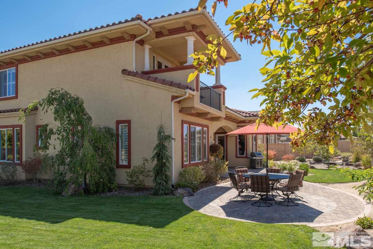 9895 Copenhagen Way Reno, NV 89521 - Photo 22 of 25 a view of a patio with table and chairs potted plants and a large tree