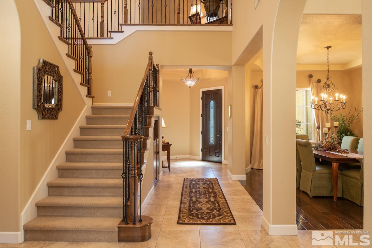 9895 Copenhagen Way Reno, NV 89521 - Photo 4 of 25 a view of a hallway with wooden floor and staircase