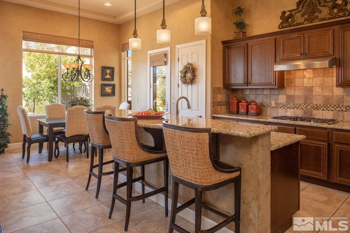 9895 Copenhagen Way Reno, NV 89521 - Photo 8 of 25 a kitchen with a table chairs and microwave