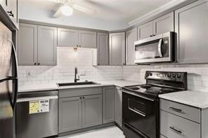 1822 North Rock Springs Road Northeast, Unit 7 Atlanta, GA 30324 - Photo 4 of 21 a kitchen with cabinets stainless steel appliances and a sink